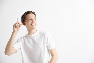 Image showing The happy student standing and smiling against gray background.