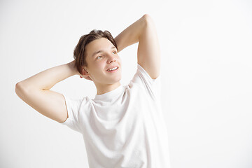 Image showing Young dreaming teenager isolated on white background looking at something