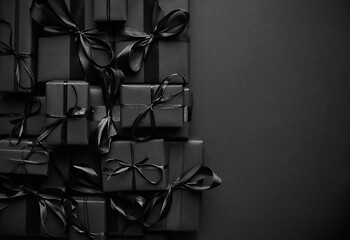 Image showing A pile various size black boxed gifts placed on stack. Christmas concept.