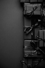 Image showing A pile various size black boxed gifts placed on stack. Christmas concept.