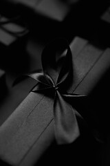 Image showing Black Christmas concept. Close up on elegant black matte wrapped gifts with ribbon.