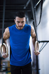 Image showing man working out pull ups with gymnastic rings