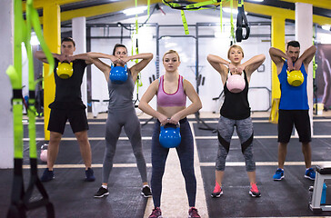 Image showing athletes doing exercises with kettlebells