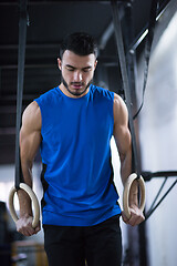 Image showing man working out pull ups with gymnastic rings