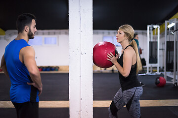 Image showing young athletes couple working out with medical ball