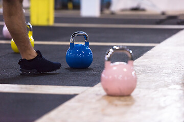 Image showing athletes doing exercises with kettlebells