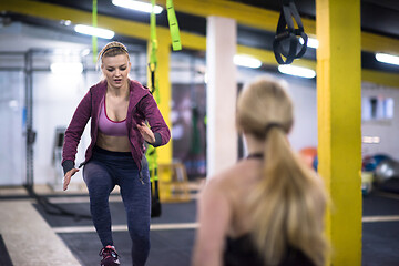 Image showing athletes working out  jumping on fit box