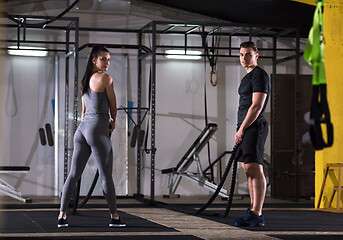 Image showing sports couple doing battle ropes cross fitness exercise