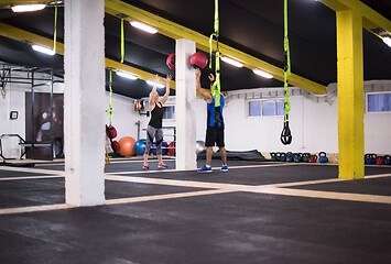 Image showing young athletes couple working out with medical ball