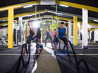 Image showing sports couple doing battle ropes cross fitness exercise