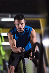 Image showing athlete man doing battle ropes cross fitness exercise