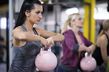 Image showing athletes doing exercises with kettlebells