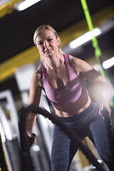 Image showing athlete woman doing battle ropes cross fitness exercise