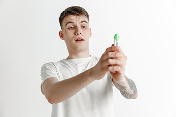 Image showing Happy man looking at pregnancy test at studio