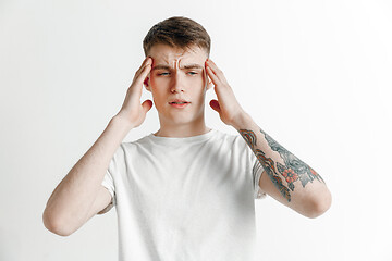 Image showing Man having headache. Isolated over gray background.