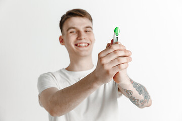 Image showing Happy man looking at pregnancy test at studio