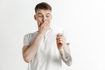 Image showing Young boy with a surprised unhappy failure expression bet slip on studio background.