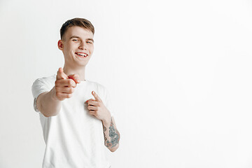 Image showing The happy businessman standing and smiling against gray background.