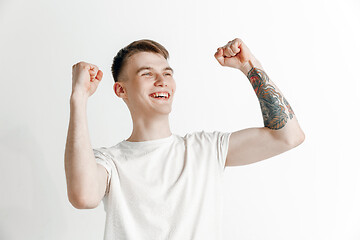 Image showing Winning success man happy ecstatic celebrating being a winner. Dynamic energetic image of male model