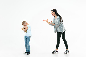 Image showing Angry mother scolding her son in living room at home