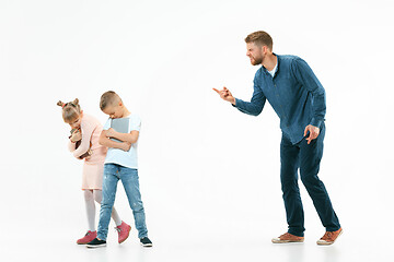 Image showing Angry father scolding his son in living room at home