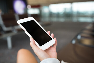Image showing Woman using cellphone in airport