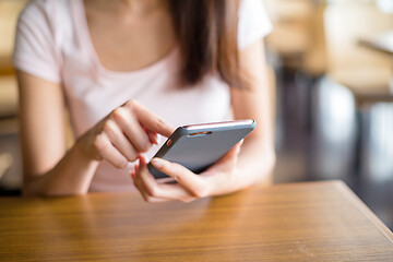 Image showing Woman using mobile phone inside cafe