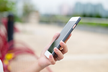 Image showing Woman sending sms on cellphone