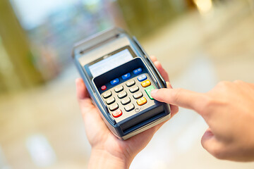 Image showing Customer finger press the button on the pos machine