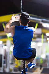 Image showing man doing rope climbing