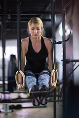 Image showing woman working out pull ups with gymnastic rings