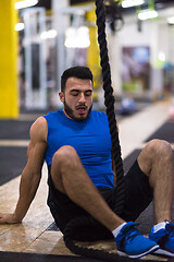 Image showing man relaxing before rope climbing