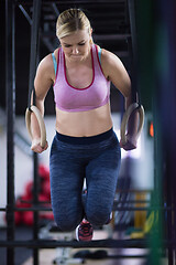 Image showing woman working out pull ups with gymnastic rings