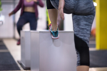 Image showing athletes working out  jumping on fit box