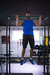 Image showing man doing pull ups on the horizontal bar