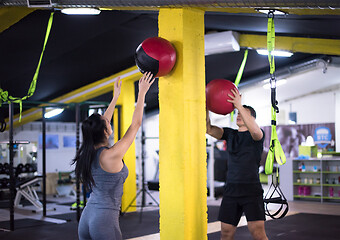 Image showing young athletes couple working out with medical ball