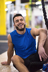 Image showing man relaxing before rope climbing