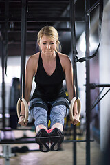 Image showing woman working out pull ups with gymnastic rings