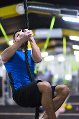 Image showing man doing rope climbing