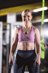 Image showing athlete woman doing battle ropes cross fitness exercise