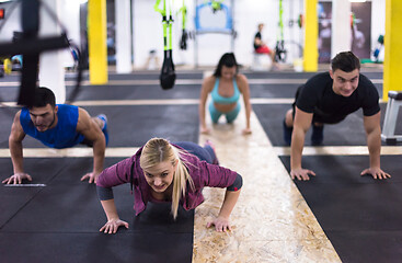 Image showing young healthy people doing pushups