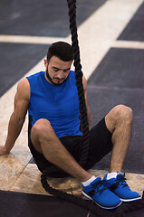 Image showing man relaxing before rope climbing