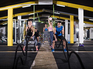 Image showing sports couple doing battle ropes cross fitness exercise