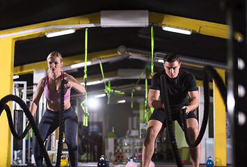 Image showing sports couple doing battle ropes cross fitness exercise