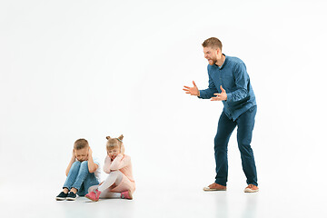 Image showing Angry father scolding his son in living room at home