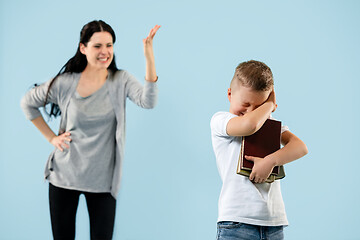 Image showing Angry mother scolding her son in living room at home