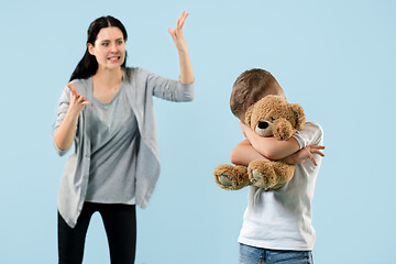 Image showing Angry mother scolding her son in living room at home