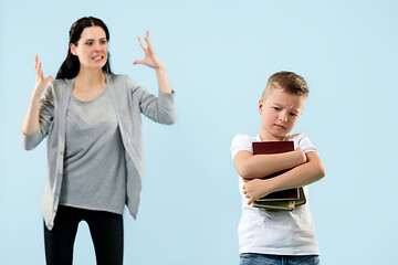 Image showing Angry mother scolding her son in living room at home