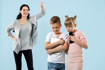 Image showing Angry mother scolding her son in living room at home