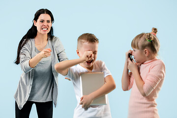 Image showing Angry mother scolding her son in living room at home